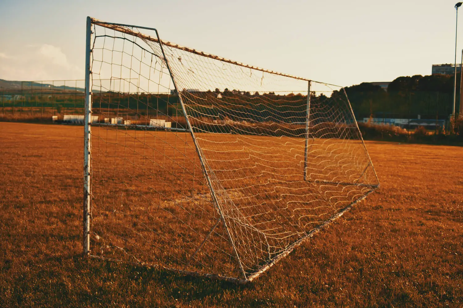 Soccer goal on brown pitch